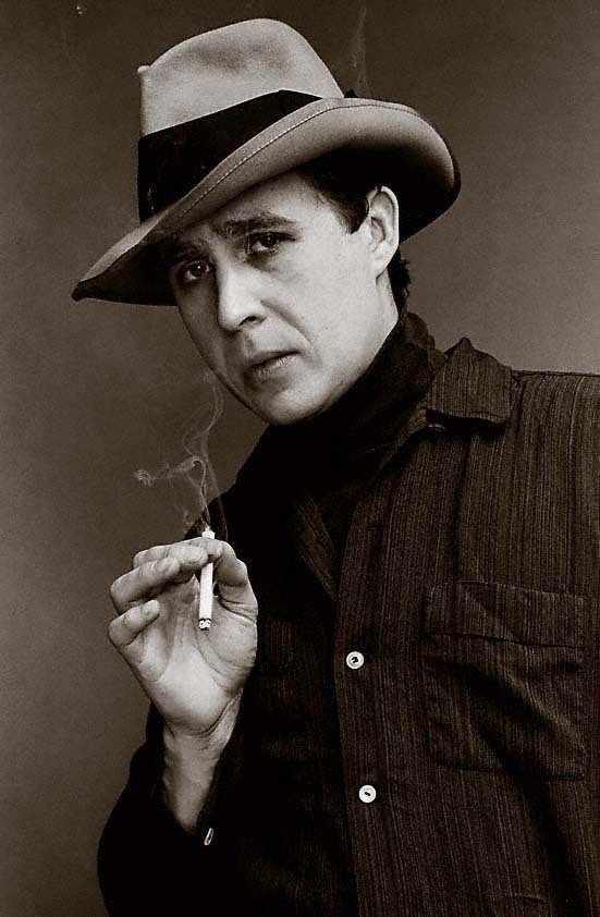 In a furnished room upstairs from the club, just off MacDougal, One-Legged Terry waits to give Bob his weekly lesson after the gig. AJ's in the alleyway rummaging through the garbage. I'm sitting tight, keeping an eye on that other guy in a fedora...

#MOJODylanLive