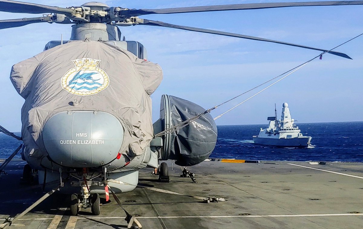 Pussbats's tweet photo. Saying hello to @HMSDefender as she approaches for a joint RAS this morning with @HMSQNLZ +  @RFATidespring 🌊⛽

Merlin helo from @820NAS in view. 🚁 #CSG21 #royal #navy https://t.co/RmnvDptDxg