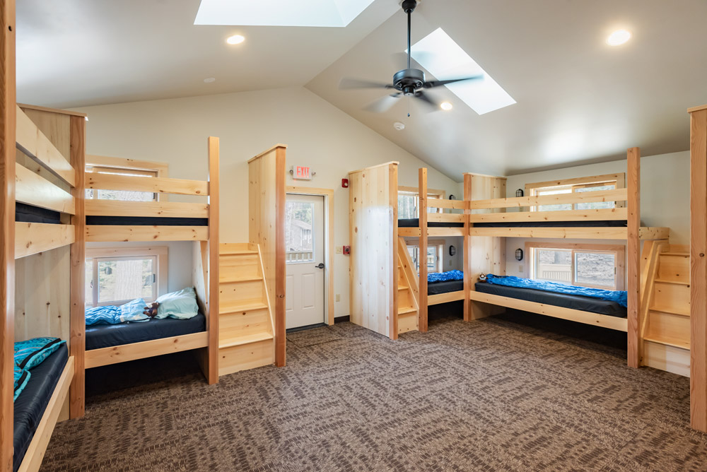 MPNarchitects's tweet photo. New Cabin at YMCA Camp Jewell in Colebrook, CT is Ready for Campers!  Replaces a dated and worn existing cabin; accommodates two separate groups of 12 campers plus a chaperone. Common living room separate from the sleeping areas. #ymca #architecture #camp https://t.co/wu9oAhnpXN