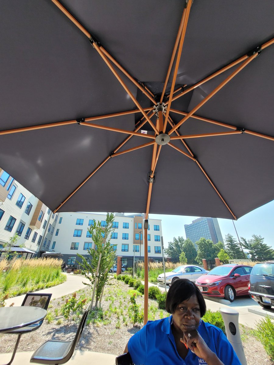 Our manager, Suzette, holding meetings in the fresh air under our new courtyard umbrellas. Enjoy this beautiful weather, everyone! #TheNewBeecherTerrace