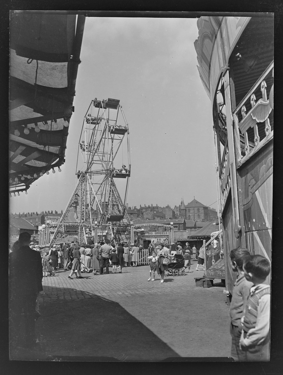 We are looking at this week. #HolidayActivities #Archiveholiday @ARAScot 

From circa 1951, a fair scene in Stalybridge. with a Ferris wheel and people waiting to get on.  Cocker Hill and the Old St George's church can be seen in the background. #SmileTameside