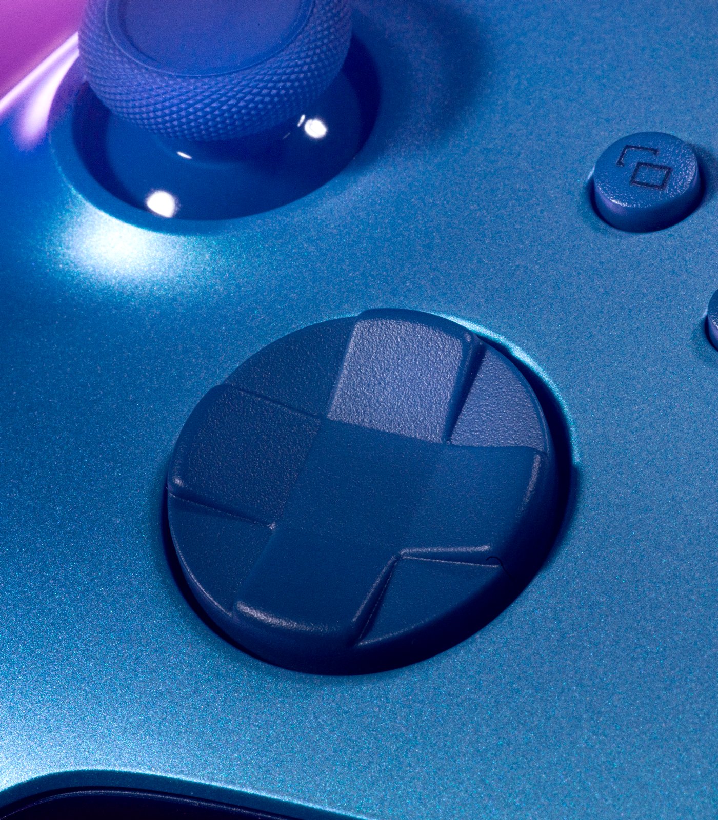 A close up of the blue Dpad of the Aqua Shift wireless controller.
