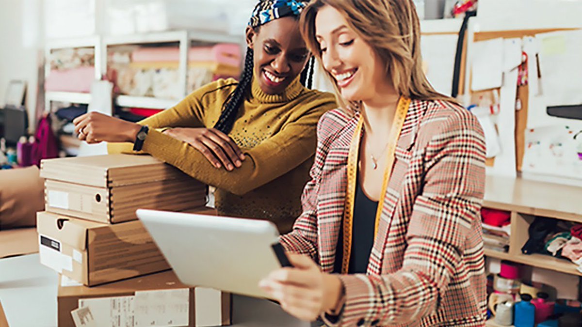 two people looking at an iPad