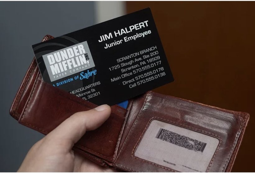 laralindsey's tweet photo. Me trying to wedge my COVID vaccine card into my wallet reminds me of when Dwight took over as “acting manager” of Dunder Mifflin-Scranton and redesigned everyone’s business cards. #designflaw #junioremployee https://t.co/iFrsQdnpFk