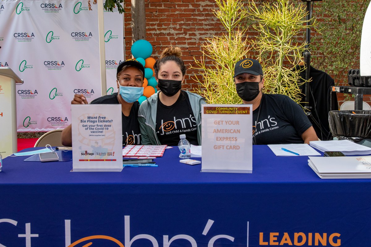 St. John's staff at check-in table for pop-up vax event in South L.A.