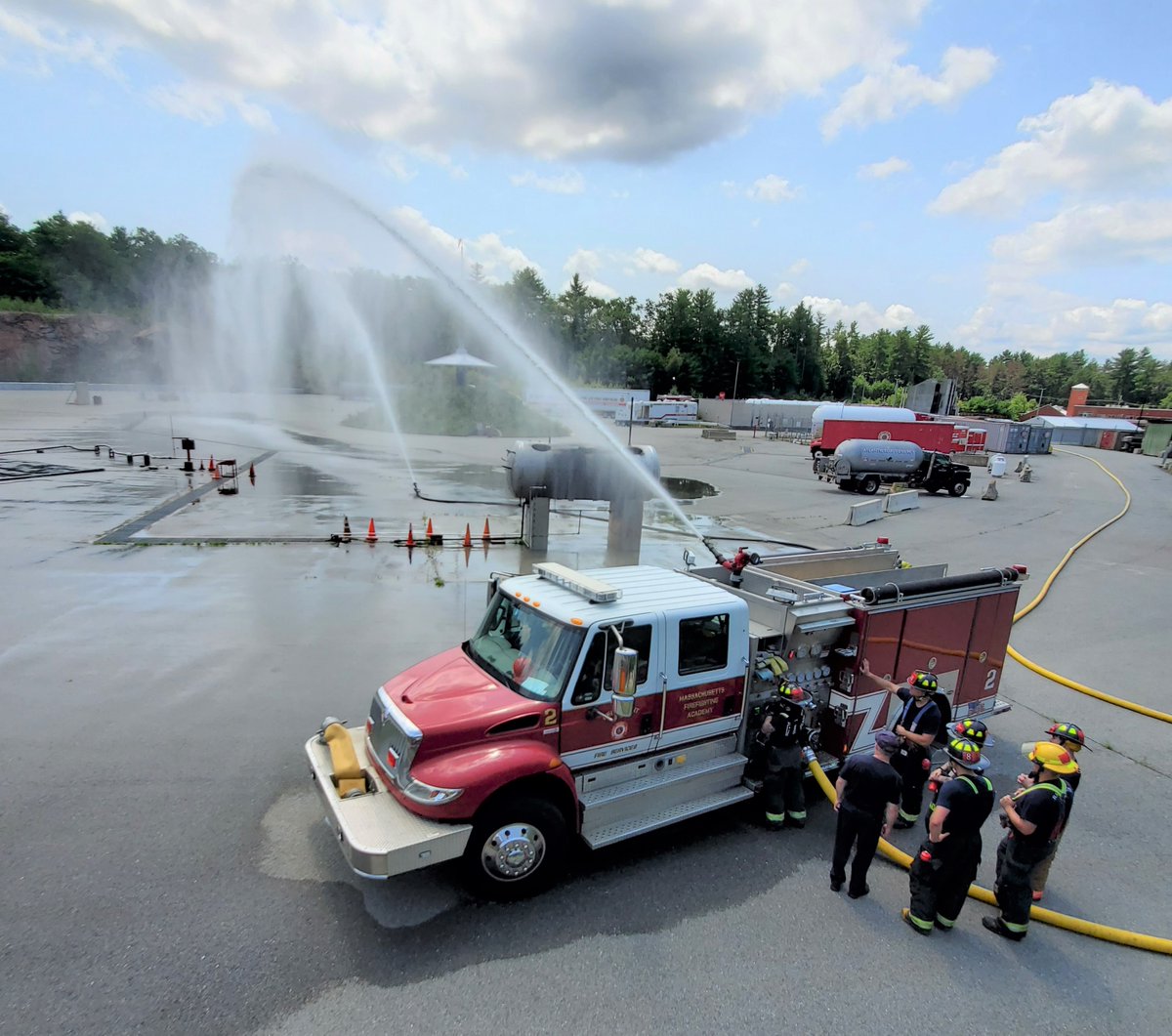MassDFS's tweet photo. #MassachusettsFirefightingAcademy #Class294 recruits participate in a double-pump evolution at the #Stow campus. During this evolution, the “attack pump” pumps a large volume of water at proper pressure after receiving water from the “supply pump” at a distant hydrant. https://t.co/HOTXCCLvUp