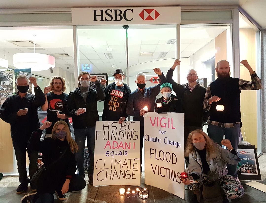 beyondcoalgc's tweet photo. We held a vigil outside of @HSBC's Southport branch on the weekend in solidarity with victims of the unprecedented floods. @HSBC, @blackrock @jpmorgan @TheOfficialSBI @mufgbk_official must divest from Adani until they drop their coal expansion plans in Aus and India. #StopAdani https://t.co/Jex56Vnizg