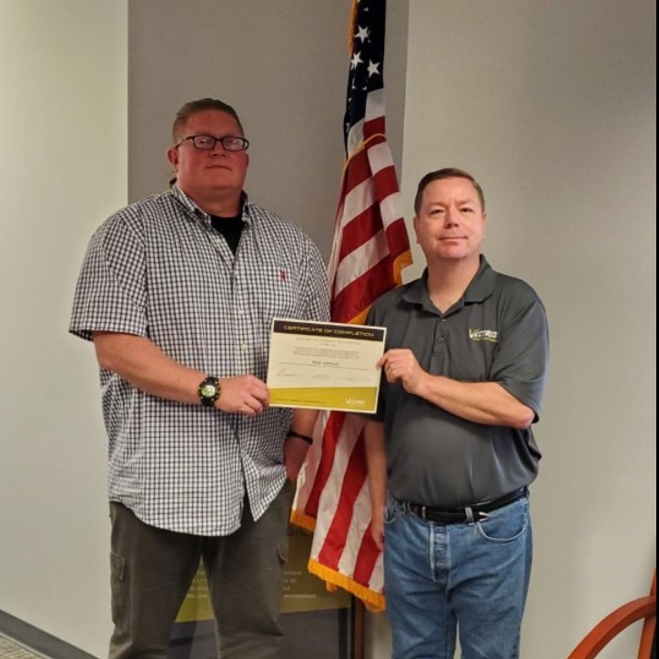 Vectrus's tweet photo. Fleet Systems Engineering Team Site Lead Chris Lamp (right) presents Neal Johnson with the 2021 Sea Warrior certificate for completing 100 days at sea. Neal supported the USS Nimitz @NimitzNews during the ship’s recent deployment. #FSET https://t.co/Ls96aq30Gj
