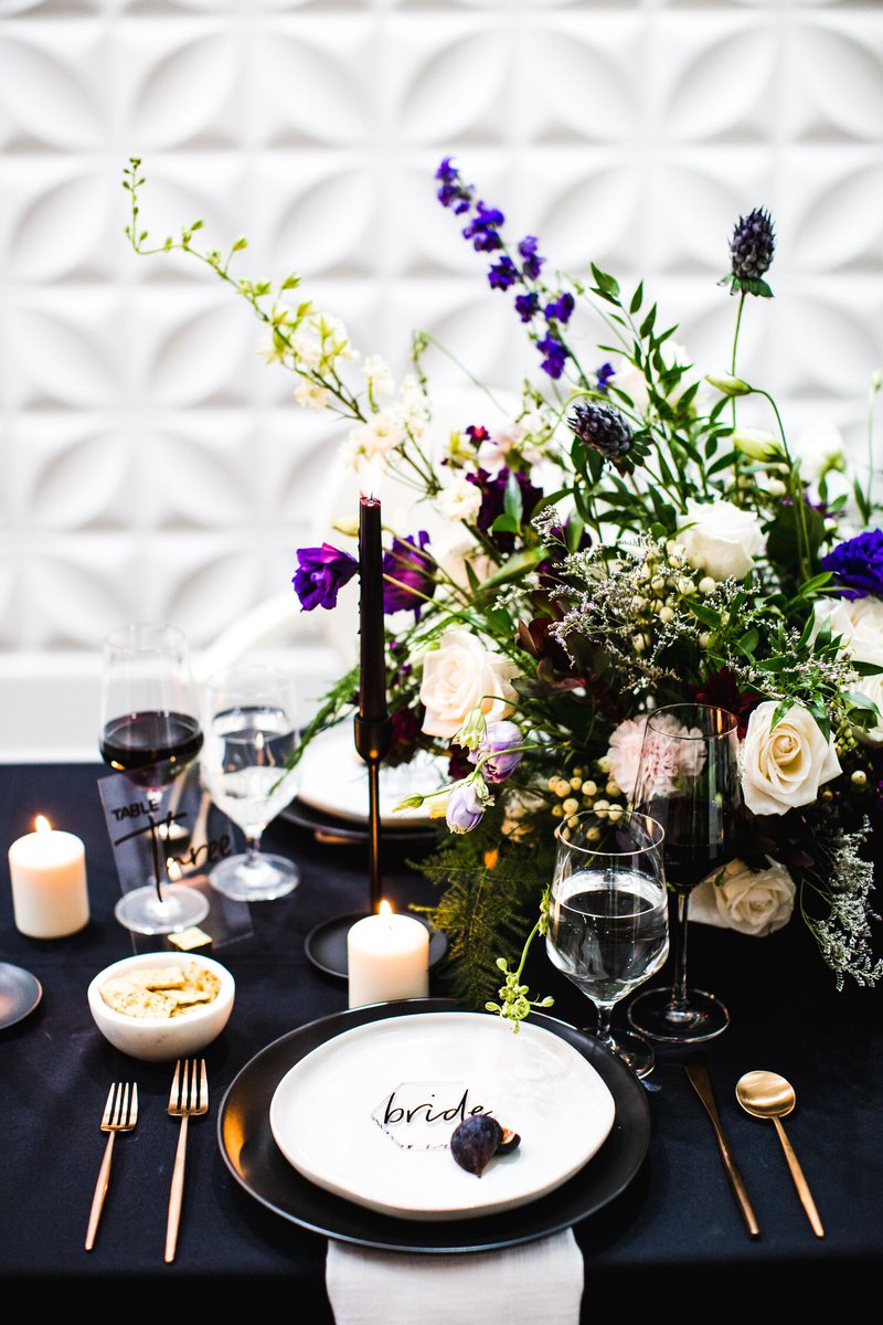 Skip the multiple floral arrangements and stacks of place settings for a more minimalist tablescape. Embrace the negative space by choosing a few key decor items that will be more cost effective and the mix of striking colors and negative space will create chic #wedding decor.