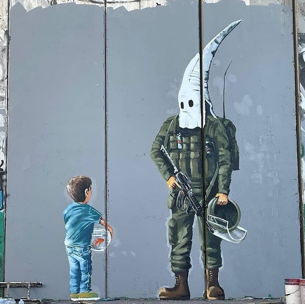new mural by the Palestinian artist Taqi Spateen on the apartheid wall in Bethlehem
