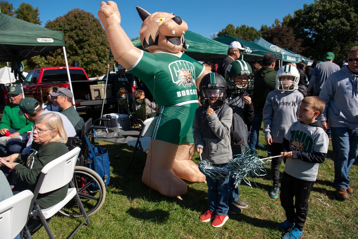 Children wearing Ohio University gear at a tailgate party.
