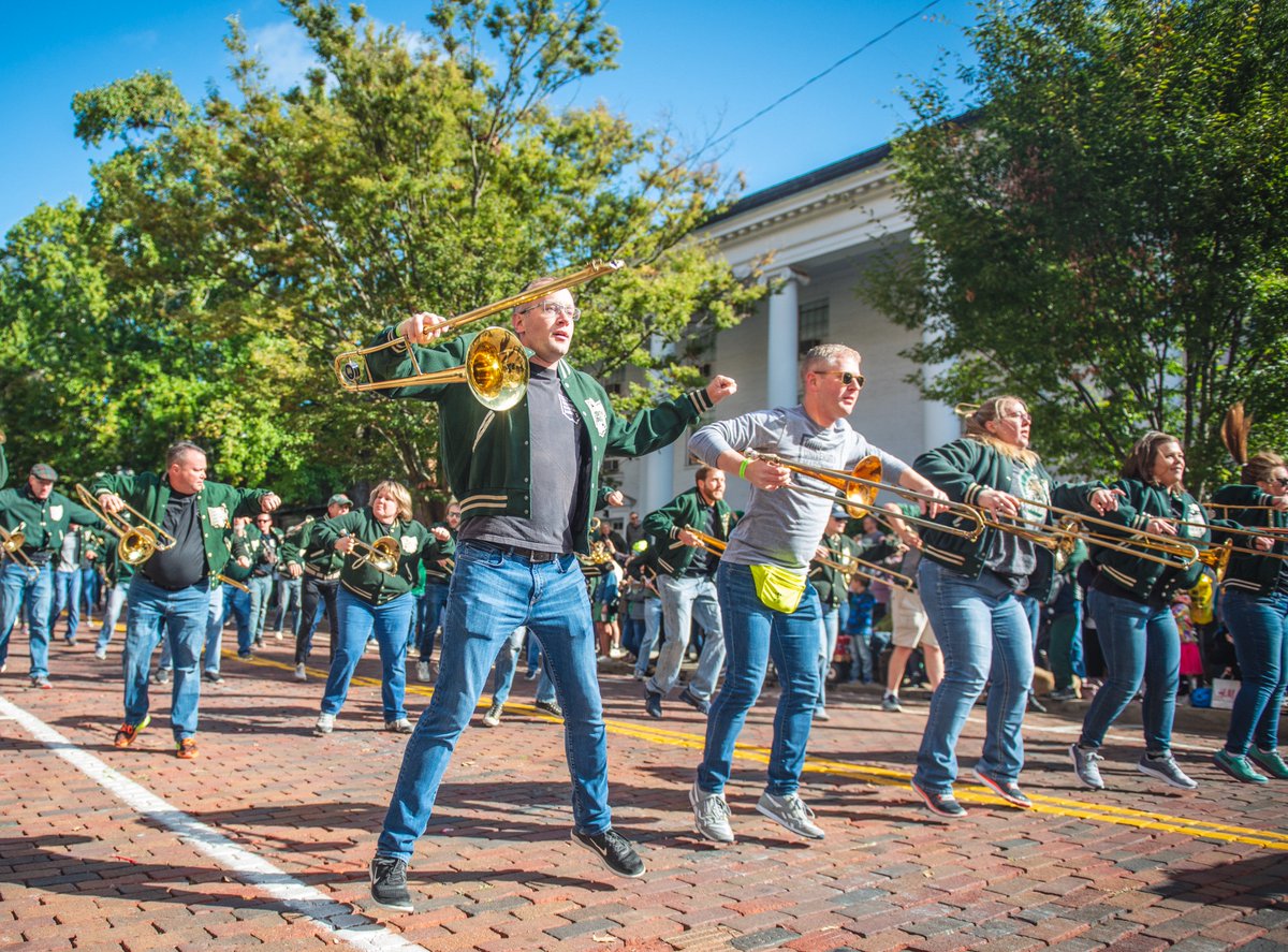 Marching 110 alumni dance in the Homecoming Parade.