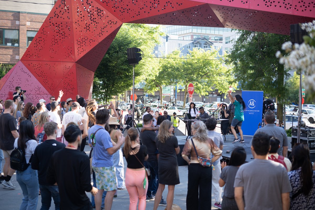 A crowd gathered around the Hing Hay Park stage as Chong the Nomad performs