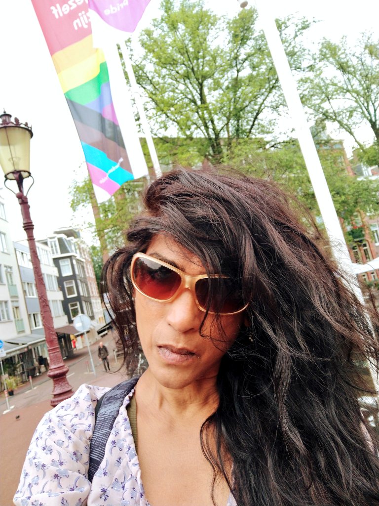 borninapartheid's tweet photo. What is she? 32 jr geleden stond ik er als studente nu in 2021 sta ik er weer deze keer voor het eerst zag ik dit wapperen! Zo mooi @AmsterdamNL dank u! Ik krijg niet genoeg van mijn fotos en selfies! #Amsterdam #WorldLeader #TheNetherlands #danielquasar #inclusive #inclusief https://t.co/HzPww4ydRX