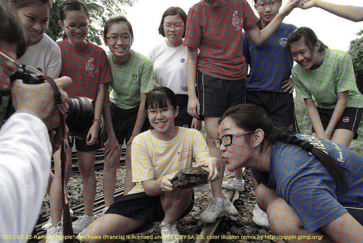 This photograph is  black and white picture. An artist has drawn some colour lines through it. The human brain is filling the rest of the colours even though they aren't there. zoom in look closely. 
We tend to fill in using the availability heuristic which is a cognitive bias.