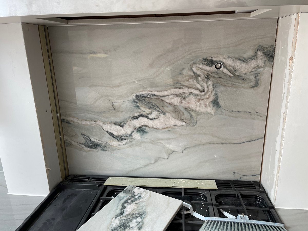 A unique looking natural Quartzite called Macaubas Fantasy, in an island layout.

A beautiful naturally decorated design features in this extremely sophisticated kitchen. This look is achieved with the seamless integration of the upstands and hob splashback.