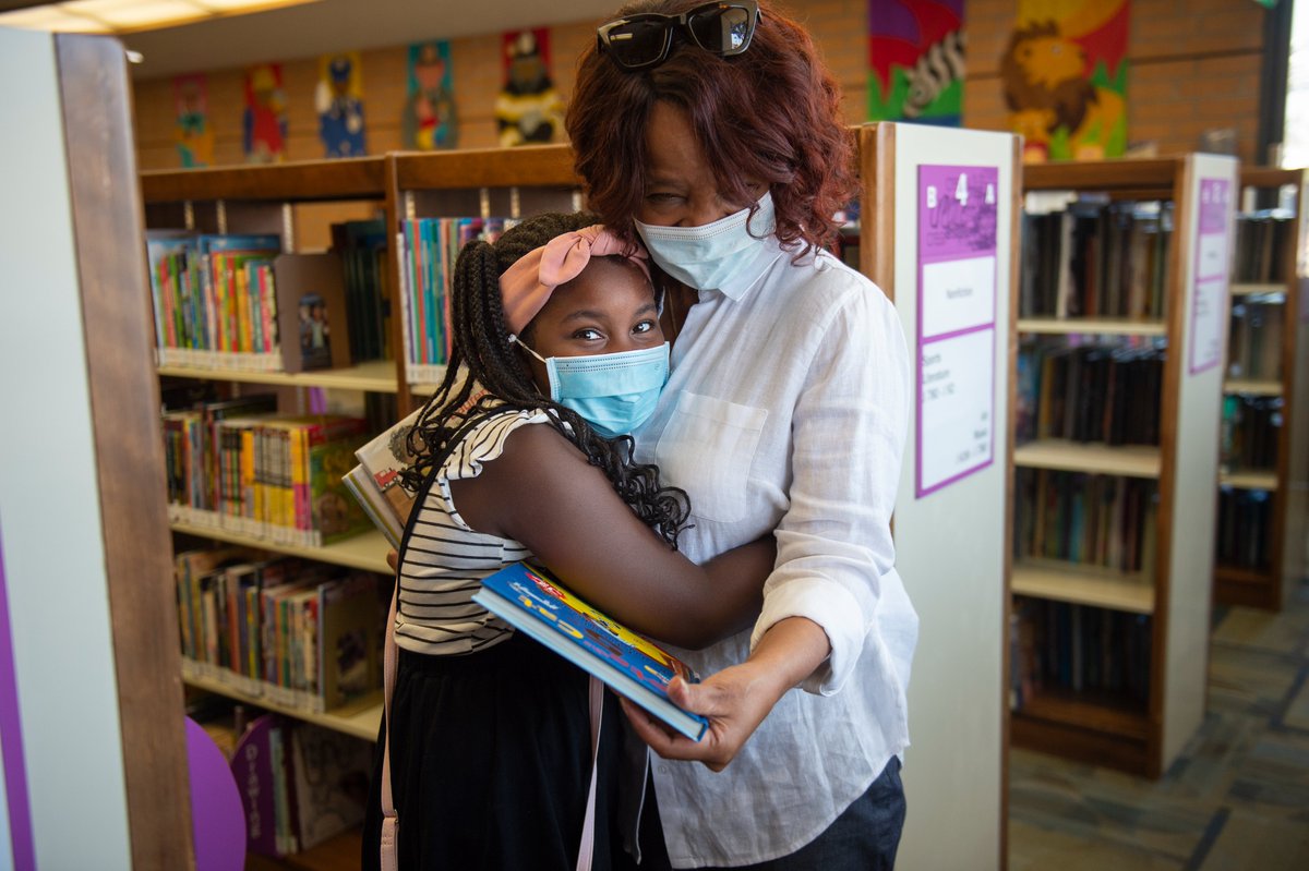 a young girl hugs her mother