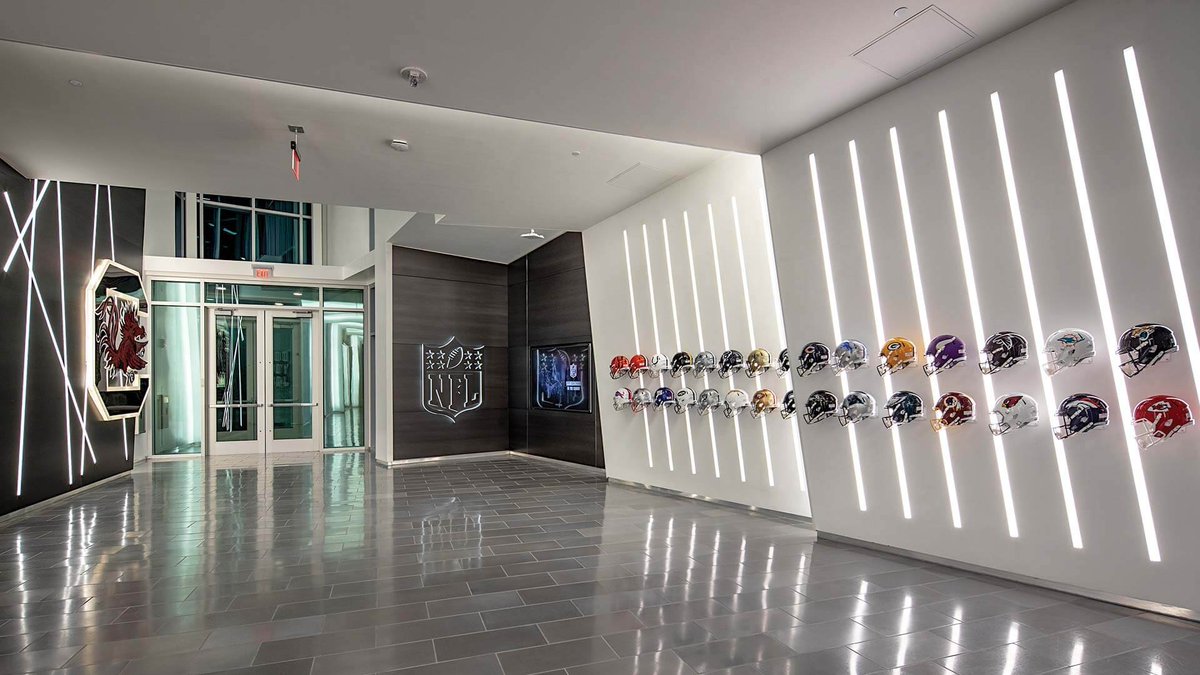 MarkLighting's tweet photo. Slot 4 draws the eye across walls of memorabilia and forms patterned designs in the Long Family Football Operations Center at University of South Carolina. See more: https://t.co/sLbjA3LuoK

#projecthighlight #marklighting #architecturallighting #lightingdesign #lightingdesigner https://t.co/5t0prc9D0O