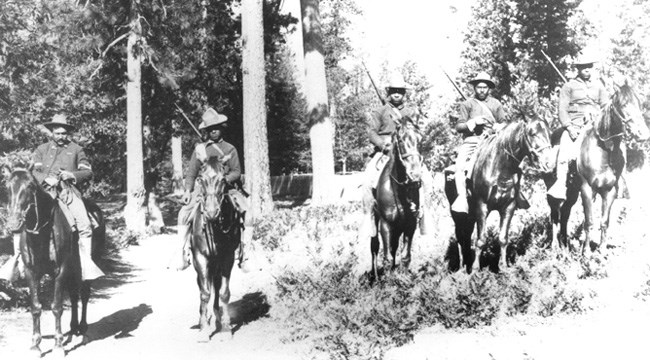 Image: Black and white photograph of Buffalo Soldiers on horseback in Yosemite National Park.