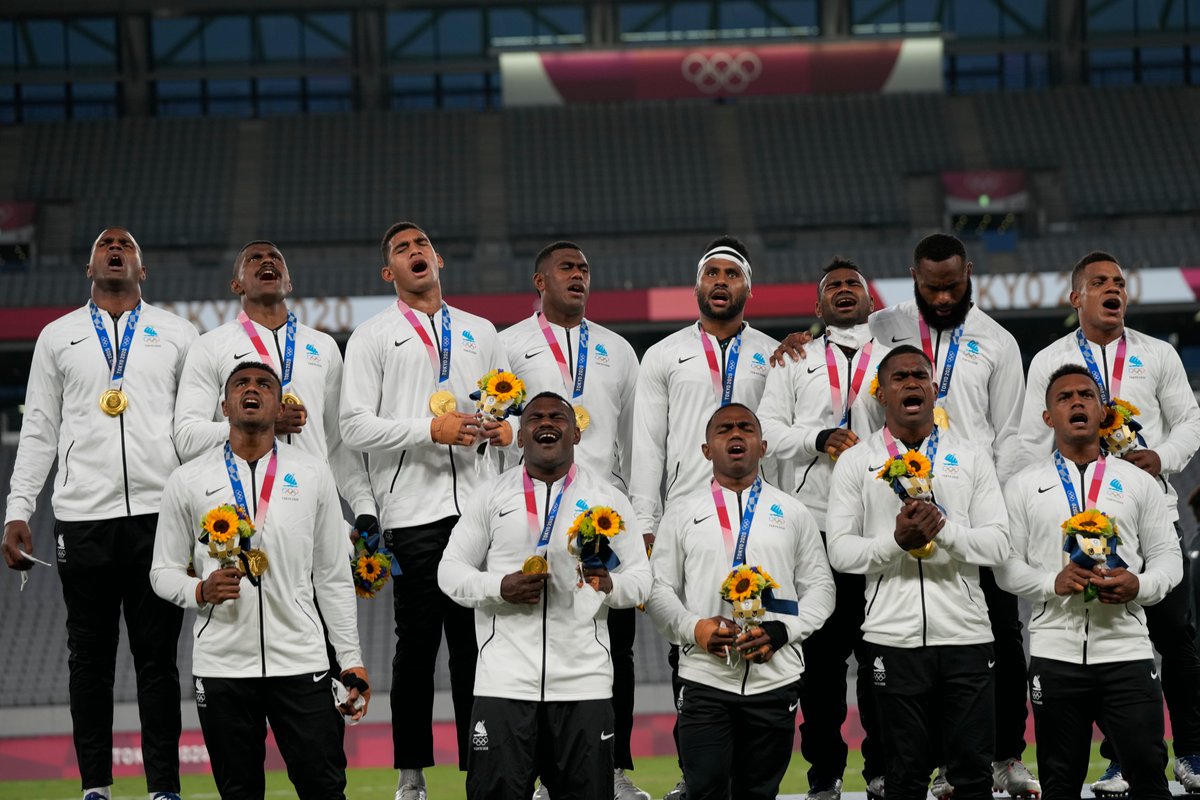 ajplus's tweet photo. Fiji's men's rugby team sang a traditional song from the podium after winning gold at the #Olympics.

Fiji is battling a major #COVID19 outbreak. The team has spent 5 months away from family, some flying to Japan on a freight plane with frozen fish because flights were canceled. https://t.co/UjT80OvUhR