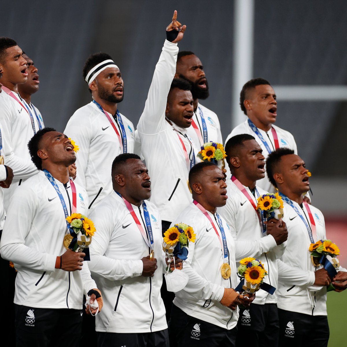 ajplus's tweet photo. Fiji's men's rugby team sang a traditional song from the podium after winning gold at the #Olympics.

Fiji is battling a major #COVID19 outbreak. The team has spent 5 months away from family, some flying to Japan on a freight plane with frozen fish because flights were canceled. https://t.co/UjT80OvUhR