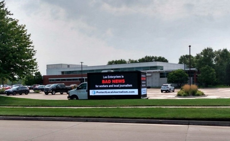 BuffaloGuild's tweet photo. We didn’t think some of the executives at @LeeEntNews heard us regarding some of their problematic proposals that would harm @TheBuffaloNews. So today we put our message on wheels and sent it to circle their Davenport, Iowa, headquarters. https://t.co/QV09widUtO