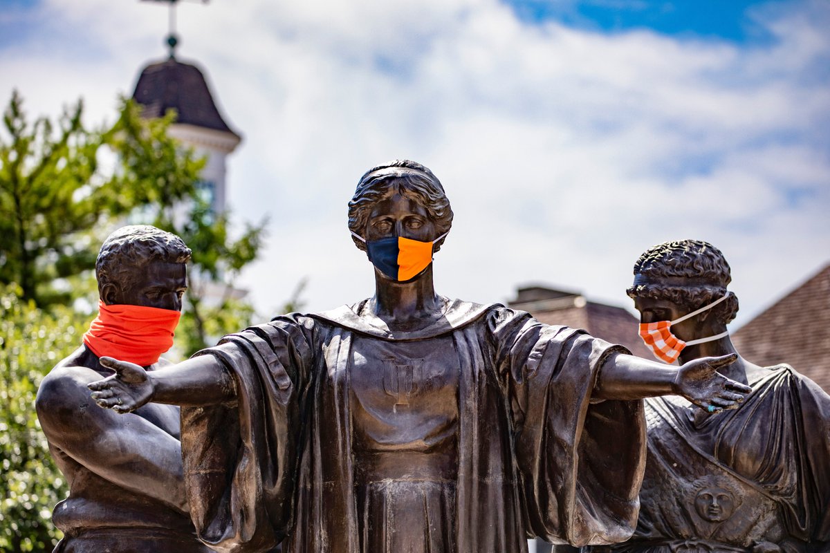 Alma Mater statue wearing orange and blue face covering