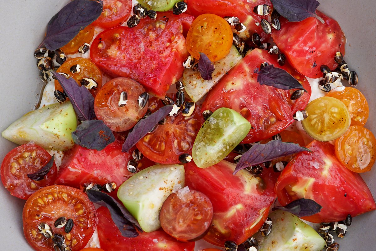 Simple and fresh, using heirloom tomatoes and tomatillos from Josh &amp; Zoe's 50/50 Farm. Chef Brad's serving this atop whipped queso fresco with chile morita oil, a dash of basil and @koda_farms black barley.