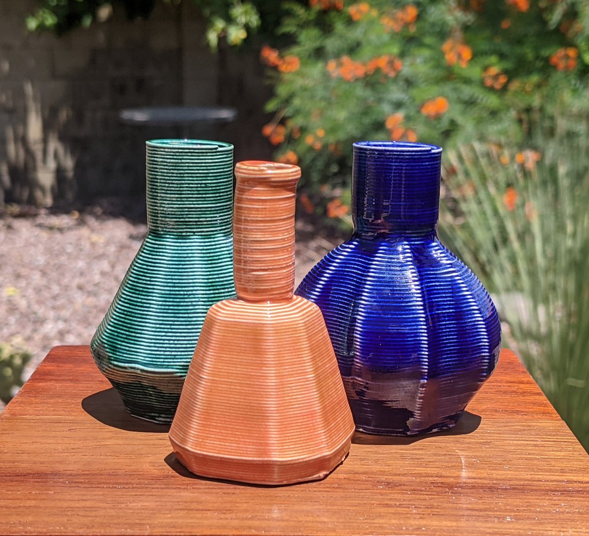 CrimsonIndustry's tweet photo. I think most of this batch turned out pretty well. I particularly like the cyan and dark green ones. Watertight, too. #3Dprinting #glaze #vase https://t.co/qhbJMp9aPY