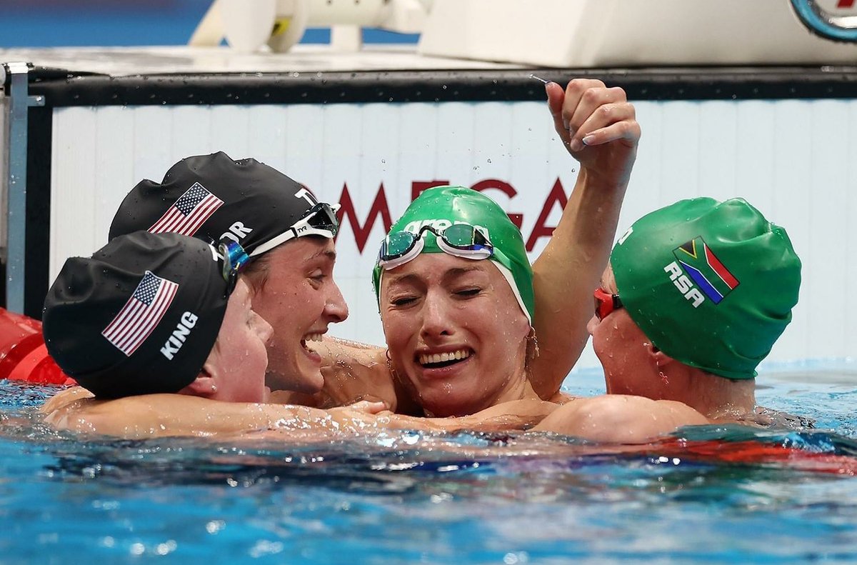 Other female swimmers (who are different nationalities) congratulate Tatjana Schoenmaker from South Africa for breaking the world record. 

World-class sportswomanship.
World-class athletes.
Amazing accomplishment.