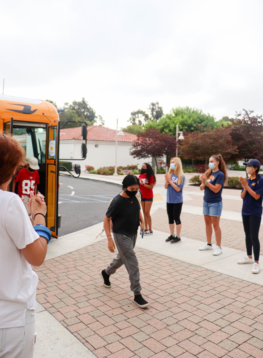 BTSJC's tweet image. Pictured are students arriving for a full day of learning and TFs to cheer them on! Let's have a great last day of the program! #BreakthroughTogether #Summer2021