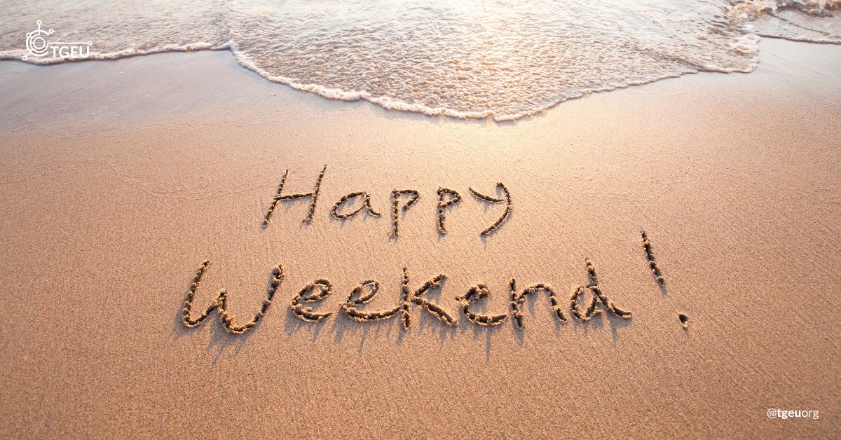 Beach with "Happy weekend!" written on the sand.