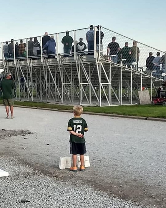 This young man set down his 4 bags of popcorn to respect the anthem at an event in Nebraska. Someone is being raised right!