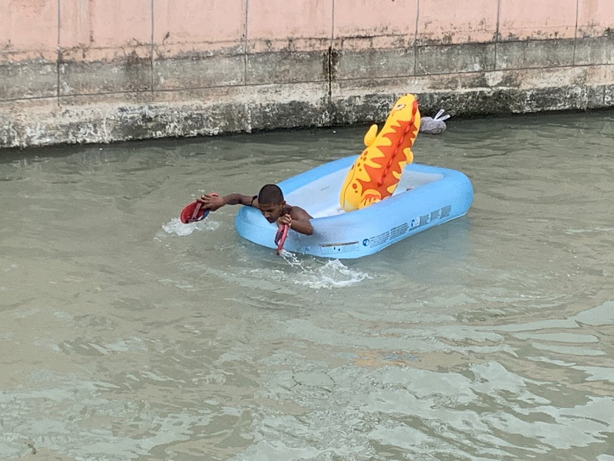 bobbyramakant's tweet image. #simplejoys #simplefun Child uses his #chappal #footwear as oars to row | #swimming in the #summer #heat! #lucknow