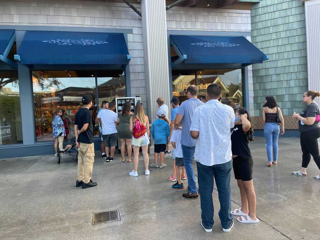 WDWNT's tweet photo. There’s a line to buy masks from a vending machine at Disney Springs https://t.co/zkfjG7zjAE