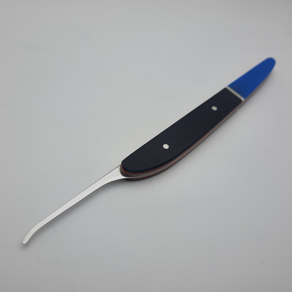 A short hook in 23thou Starrett 667, the handle I made with 4 colours of G10, 1mmx2mm sterling silver strip and 2mm sterling silver pins.

The outer scales I epoxied 'in hand' without using clamps, this way I could apply pressure in multiple directions using my fingers #locksport