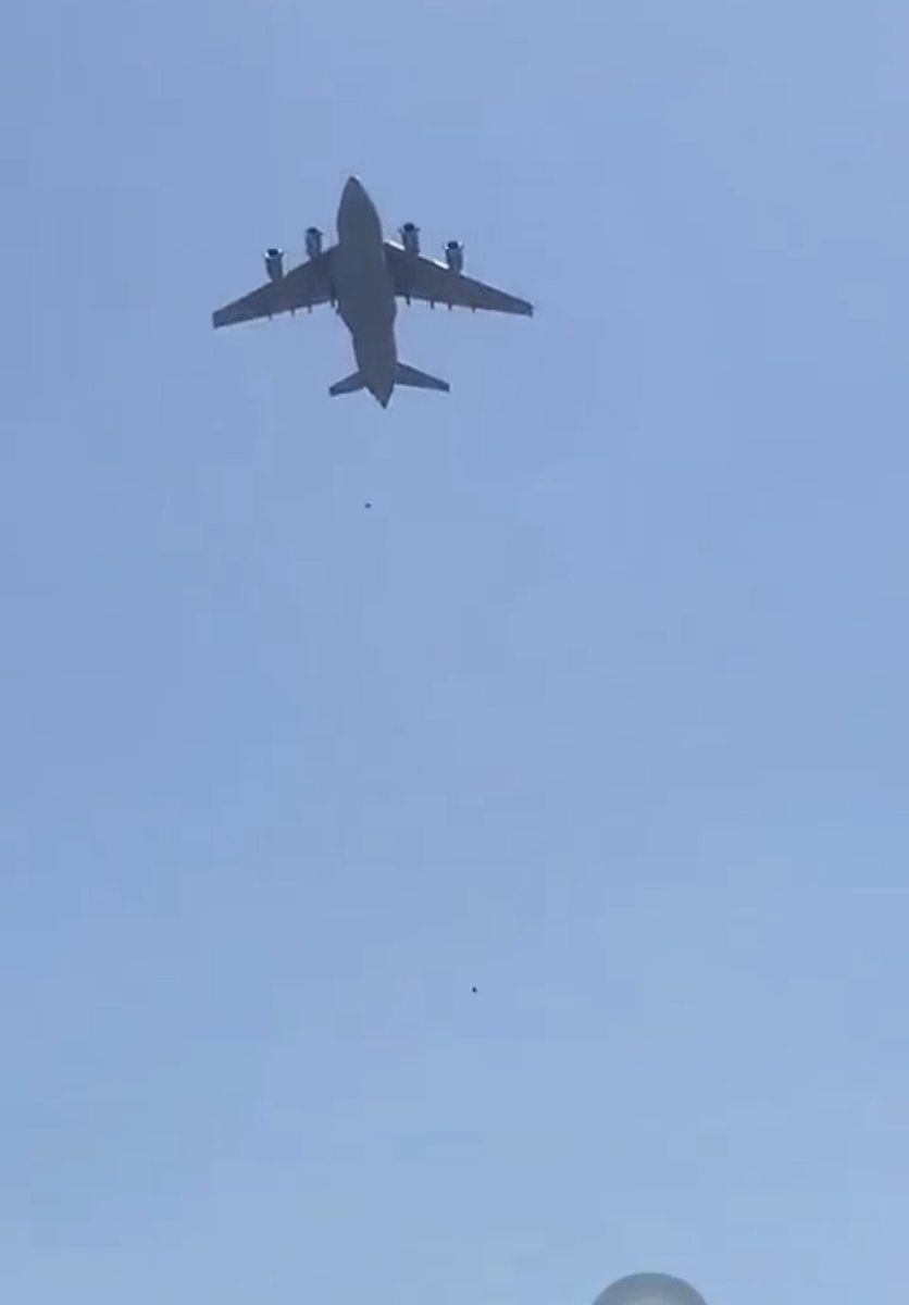 qaummunist's tweet photo. the two black dots in photo (1) are of two afghans who tried desperately to cling onto an airplane to escape kabul. photo (2) is the famous 'falling man' photograph of a person falling from the WTC during the 9/11 attacks. 

two visuals, connected in history, violence, politics. https://t.co/fsmBqqErRR