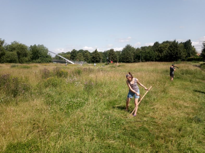 StNicksFields's tweet photo. With summer well and truly in the air, tis the season for scything! Our wonderful Eco-Active volunteers started to mow the meadow at Millennium Fields during their last session – hard work in such high temperatures! https://t.co/UOzlnqX7hx