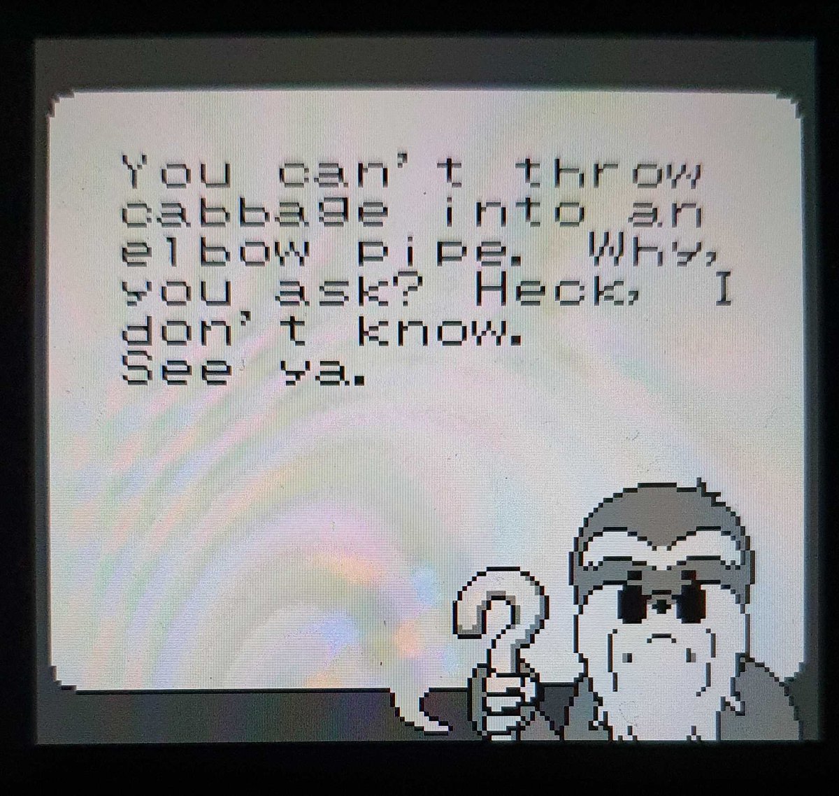 A screenshot from the game, where an old mole with glasses, beard and a cane, and a speech bubble saying "You can't throw cabbage into an elbow pipe. Why, you ask? Heck, I don't know. See ya."