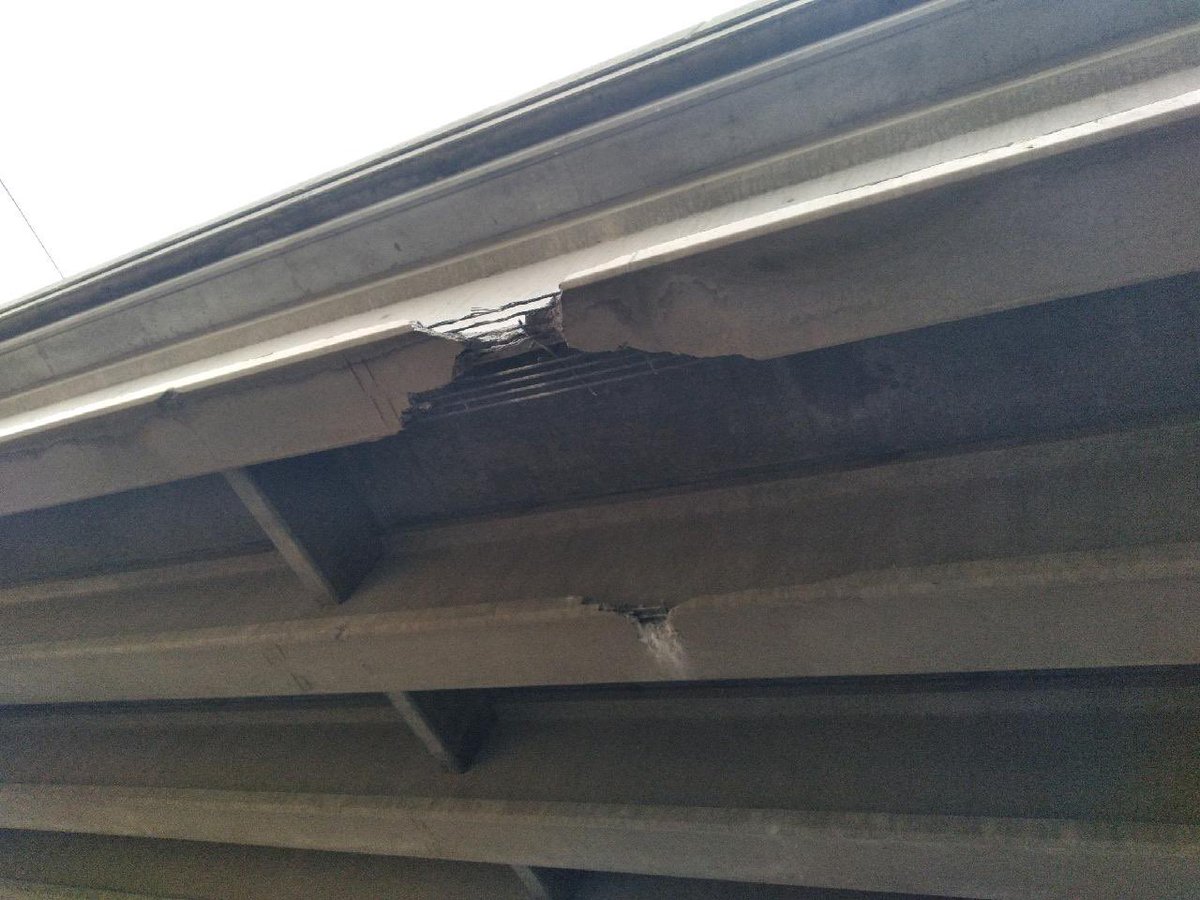 WSDOT_East's tweet photo. Here are pictures of the bridge strike to US 2 over Geiger Blvd. Most significant damage is to the eastbound US 2 structure where crews have reduced US 2 to one lane. Westbound US 2 is not affected at this time. Geiger Blvd. remains closed. https://t.co/gR9eCkFcec