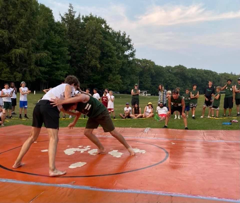 CampMenominee's tweet photo. Big Beers coaching and encouraging Lil Beers in the Greens big win in the Wrestling Meet last night! #CMBrothers #CMLegacies #CMFamily #BleedingGreen #GreenAndWhite #CM2021 #SumersHere (credit: Brett Weiss) https://t.co/0mKHYrzyti