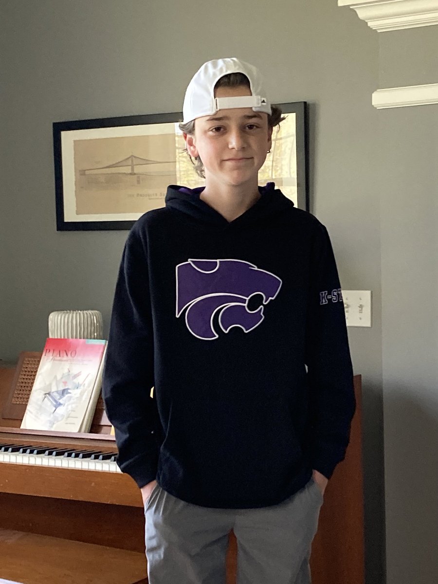 DavidRosowsky's tweet photo. A few years back Leo started following the Vikings. (Hey, he had one of the colors right!) Today he is the newest @kstate Wildcats fan. 💜🤍 #perfectinpurple https://t.co/aDXudQqAwi