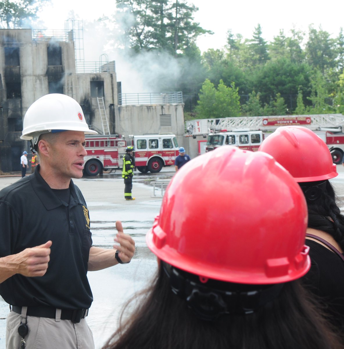 MassDFS's tweet photo. Special Operations Coordinator Tim Howe recently led a group of high school students on a tour of the DFS Stow campus, where they got a chance to watch #MassachusettsFirefightingAcademy #Class294, #Class295, &amp; #ClassBW12 training on the drill yard. #SafetyFirst #PublicEducation https://t.co/OOQ0ftnRZK