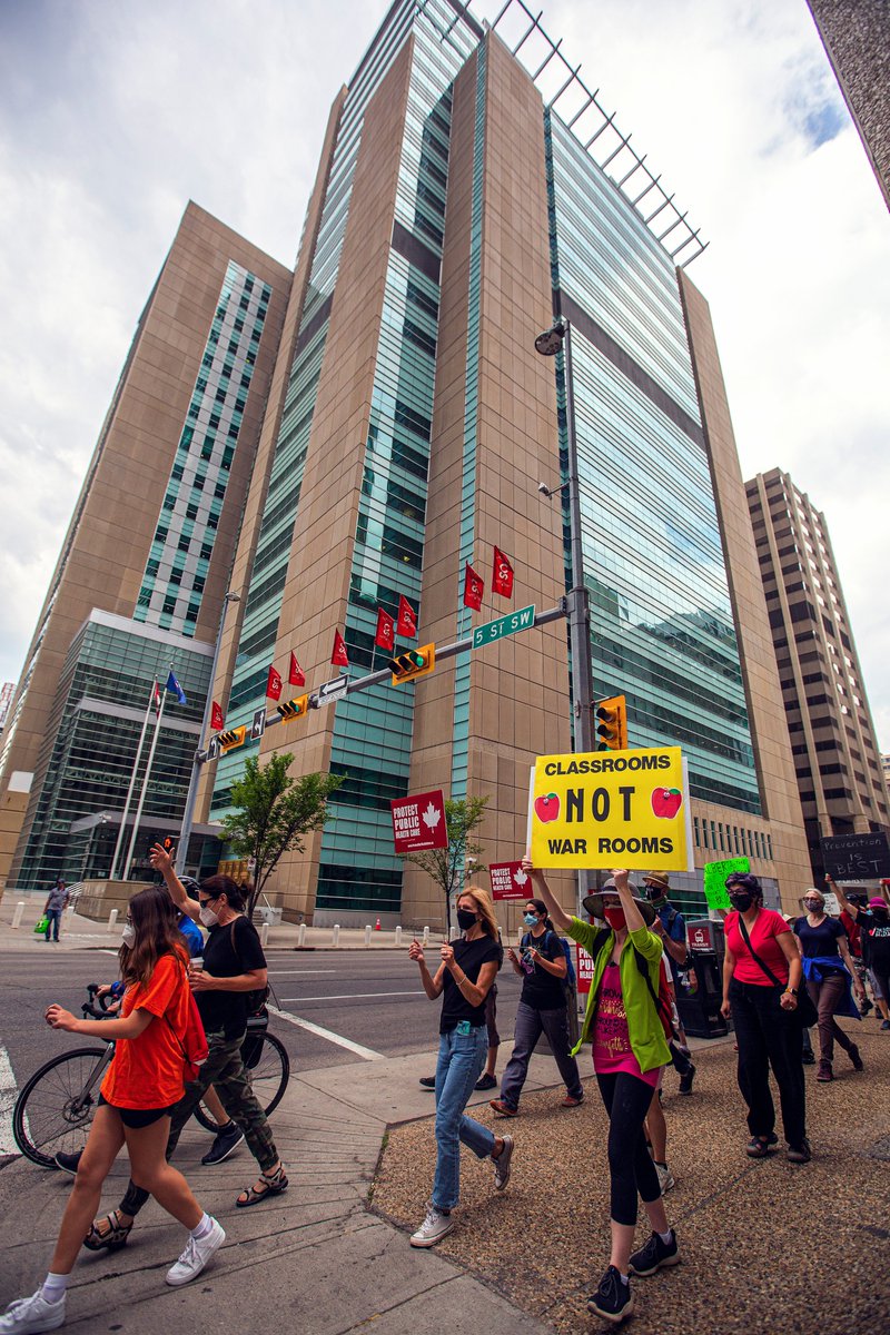 ArynToombs's tweet photo. Protests to restore testing, tracing, and isolation for Albertans with #covid19 continues for the 9th day in Calgary. Owing to altercations with anti-maskers yesterday, protestors took to marching in the downtown core. https://t.co/gSJDC6nuSr