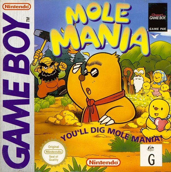 The cover for the Game Boy game, "Mole Mania". Shows Muddy Mole, the main character, popping out of a hole on the ground. Jinbe, the farmer is coming towards him from the left. On the right, you can see his wife, children and the elder mole.