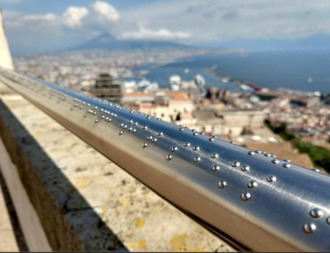 This railing on gazebo in Naples has braille describing the view for blind people. More of this please.