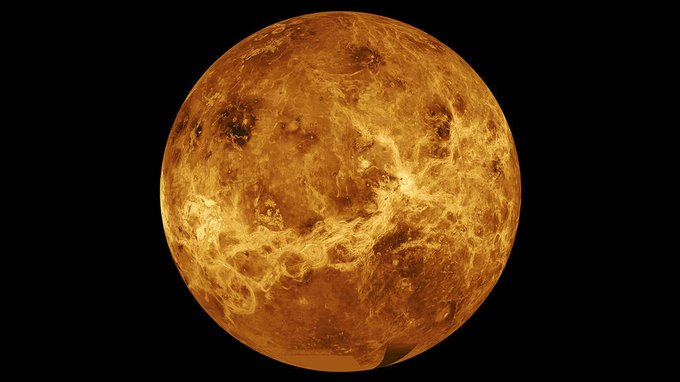 This image of Venus is a composite of data from NASA's Magellan spacecraft and Pioneer Venus Orbiter. The planet glows orange and yellow against a black background.