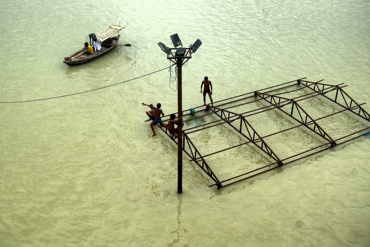 Boys along with local boatmen play atop a submerged structure at Daraganj Ghat, one of the flooded banks of the Ganges River near Sangam #india #photography #asain #everydayindia #everyday #gettyreportage #creative #indiapictures #everdayeverywhere #indiaphotoproject #indiaphoto