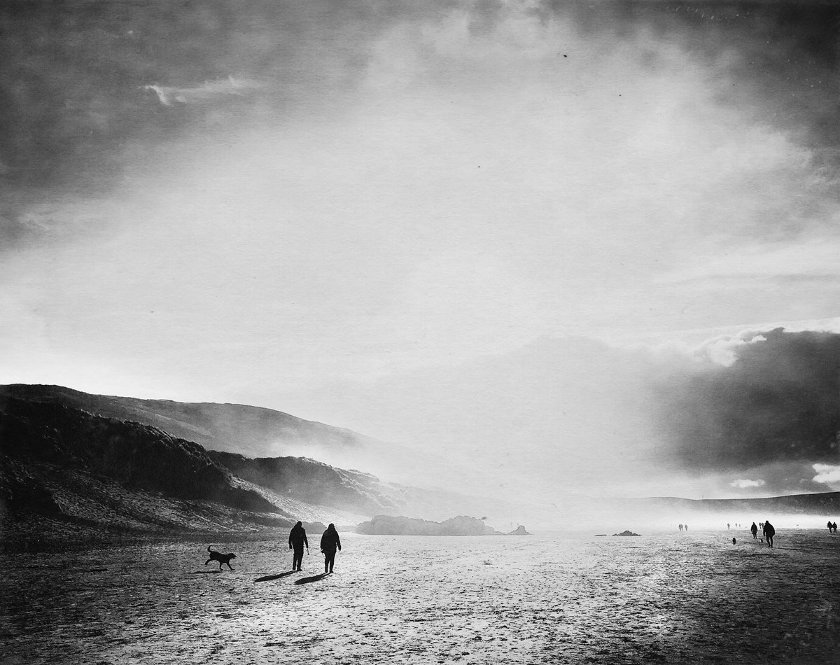 Walking the dog on the beach. Something I’m looking forward to when my pups a bit older. #beach #walk #dog #blackandwhite #light #woolacombe #photography #goals #printyourwork #clouds #morning