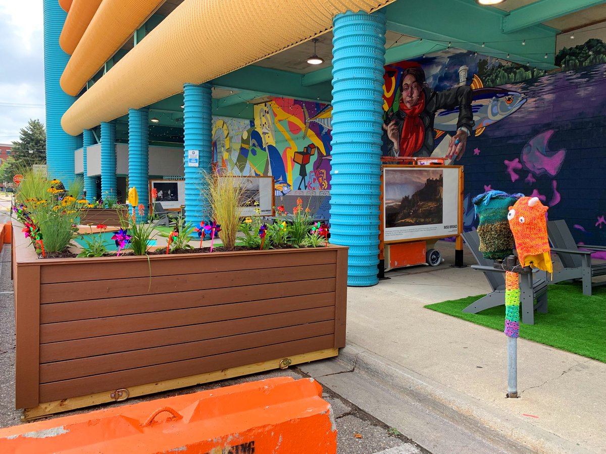 CityofEL's tweet photo. The north side of @DowntownEL's Division Street Garage has been transformed into such a colorful and inviting space for the community thanks to the #PlaceProject placemaking efforts and the "Life is a Groovy Opportunity" mural! We are loving @WovenArt's yarn bombs as well! https://t.co/kHFg11zzIK